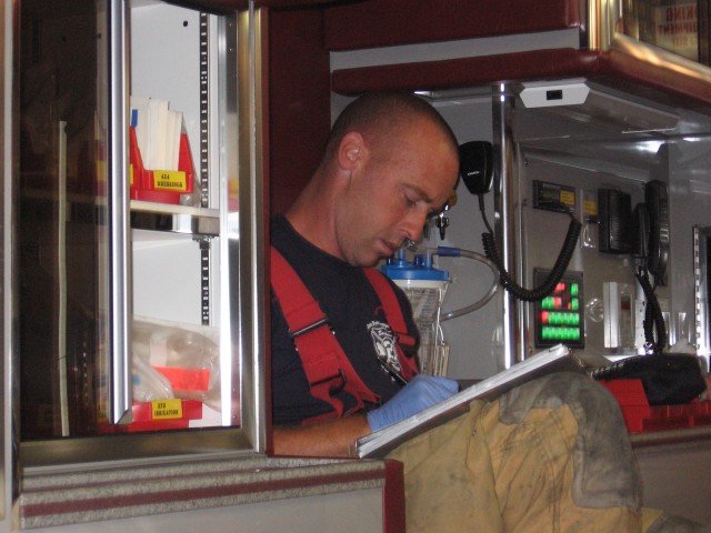 Firefighter/EMT Dave Messaros obtaining patient information.